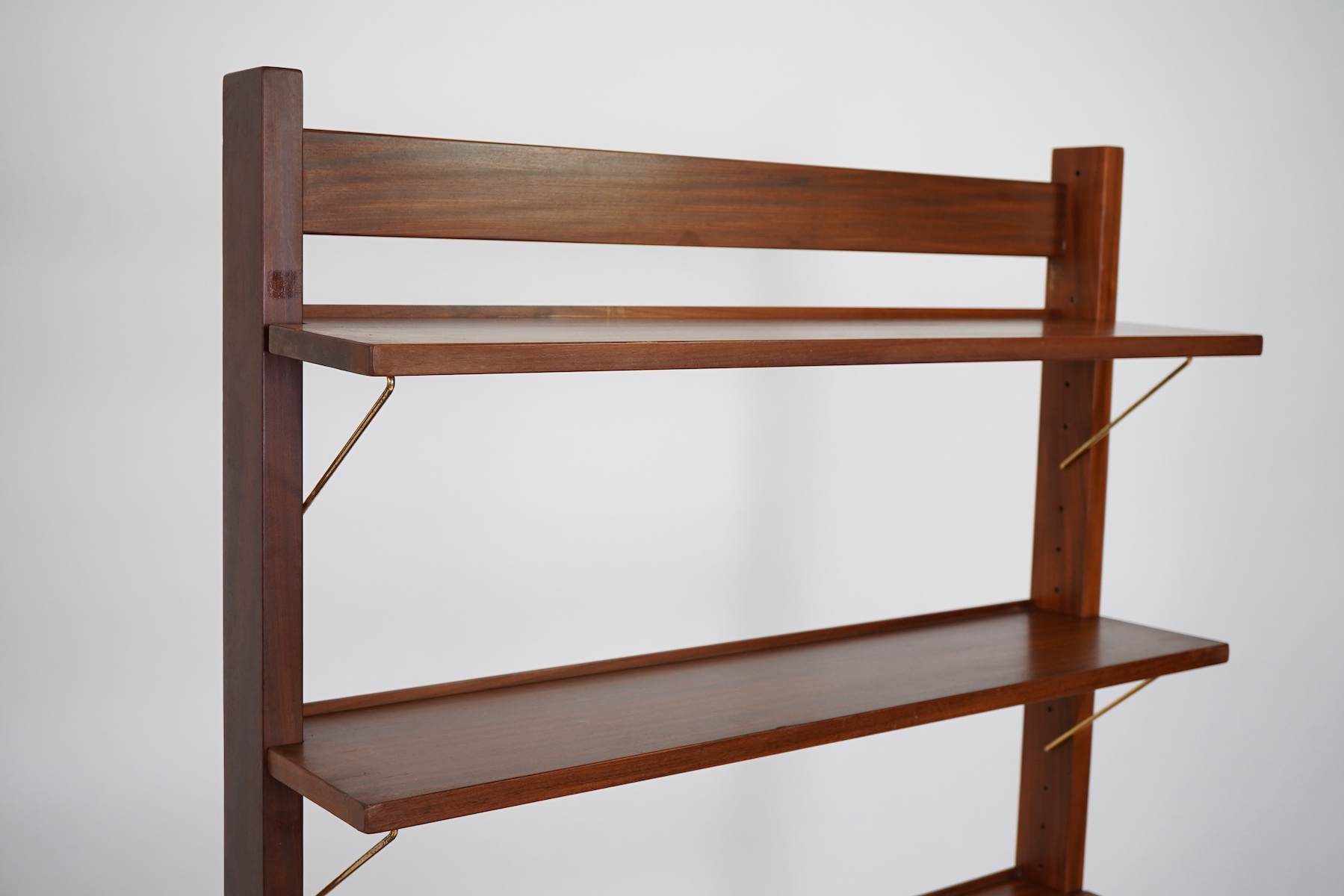 George Fejér (Hungarian, 1912-1996) for Guy Rogers of Liverpool: A 'Beverly Hills' mid-century hall stand shelving unit and matching occasional table